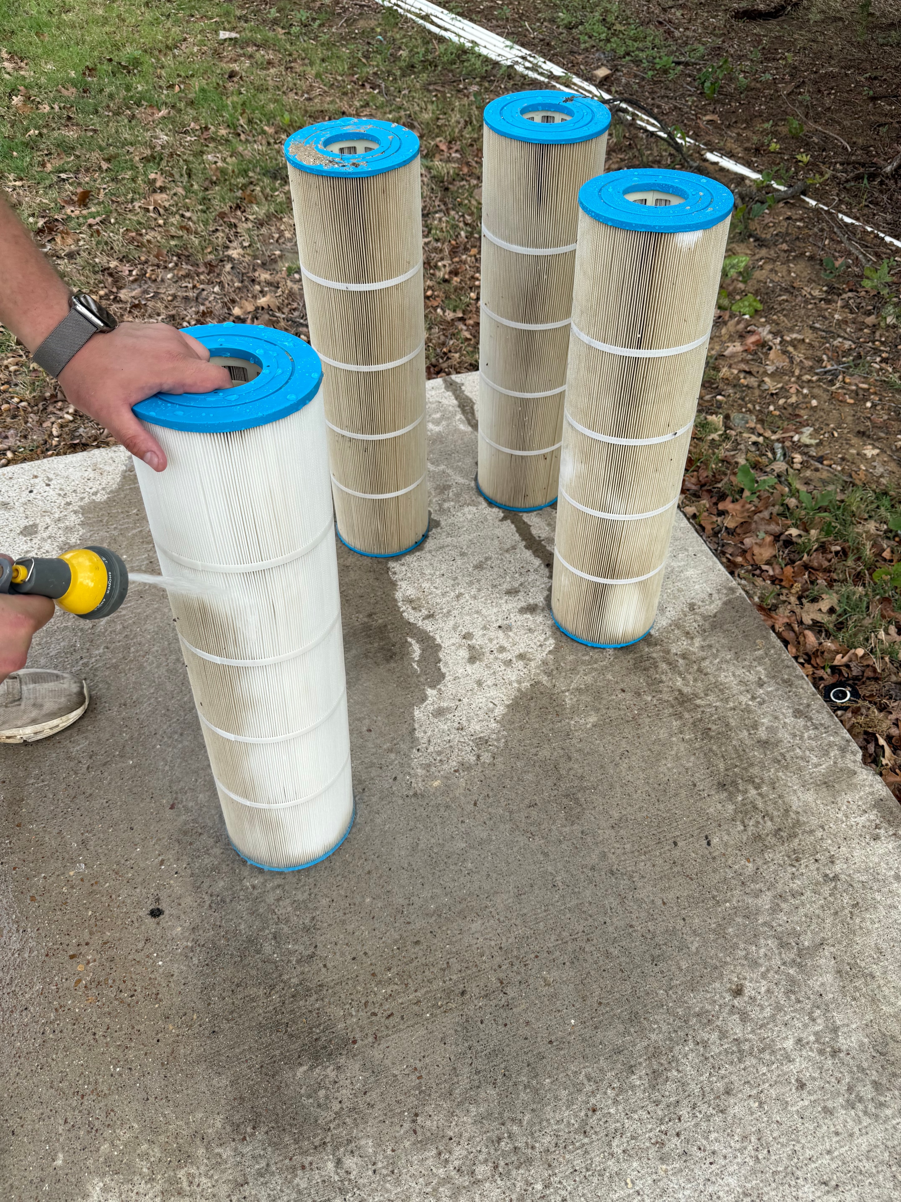 Clean pool filter cartridges after service