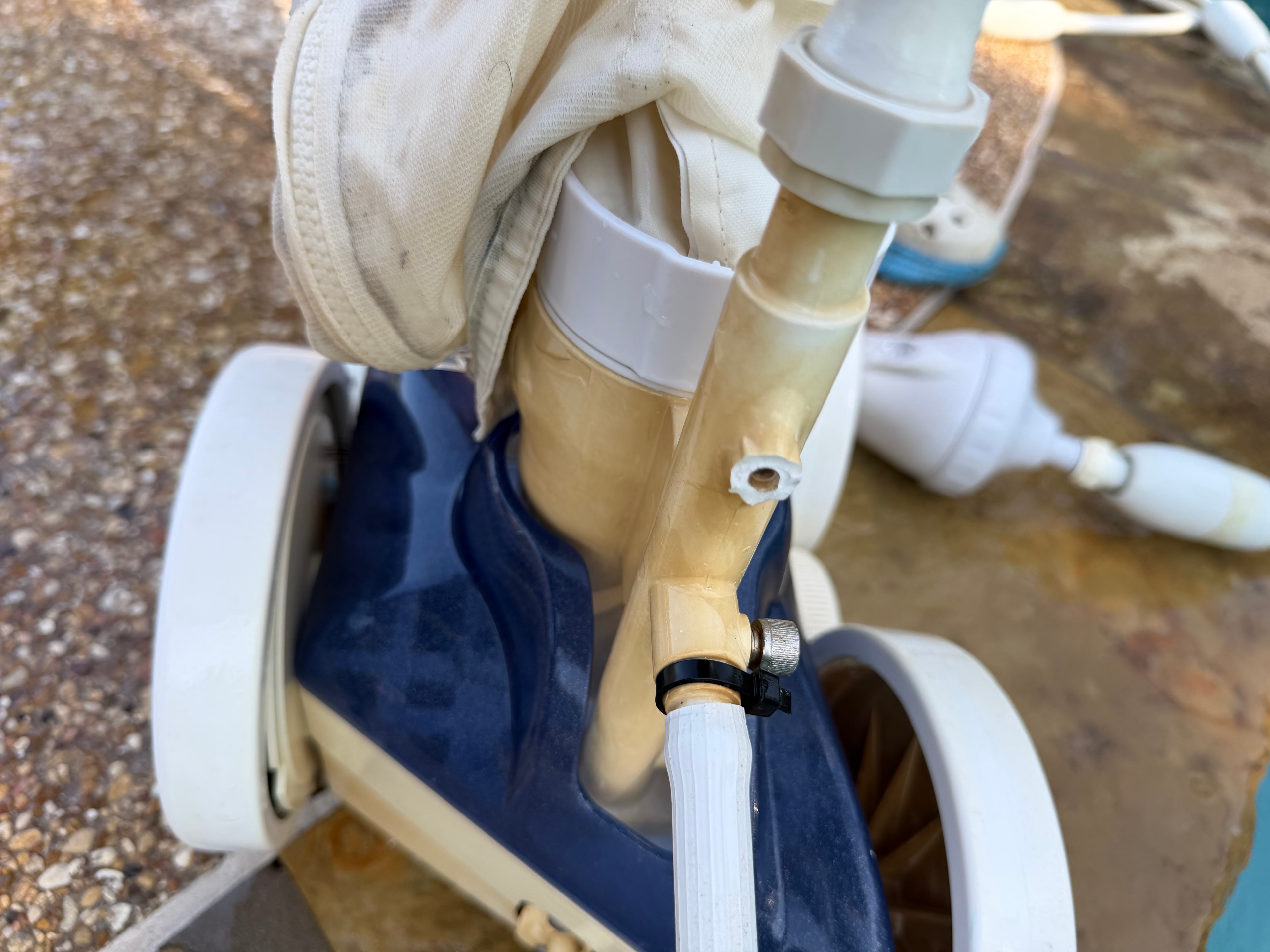 Pool cleaner disassembled showing worn internal components before repair