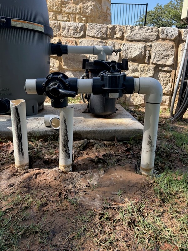 Pool pump reinstalled mid-repair with exposed plumbing